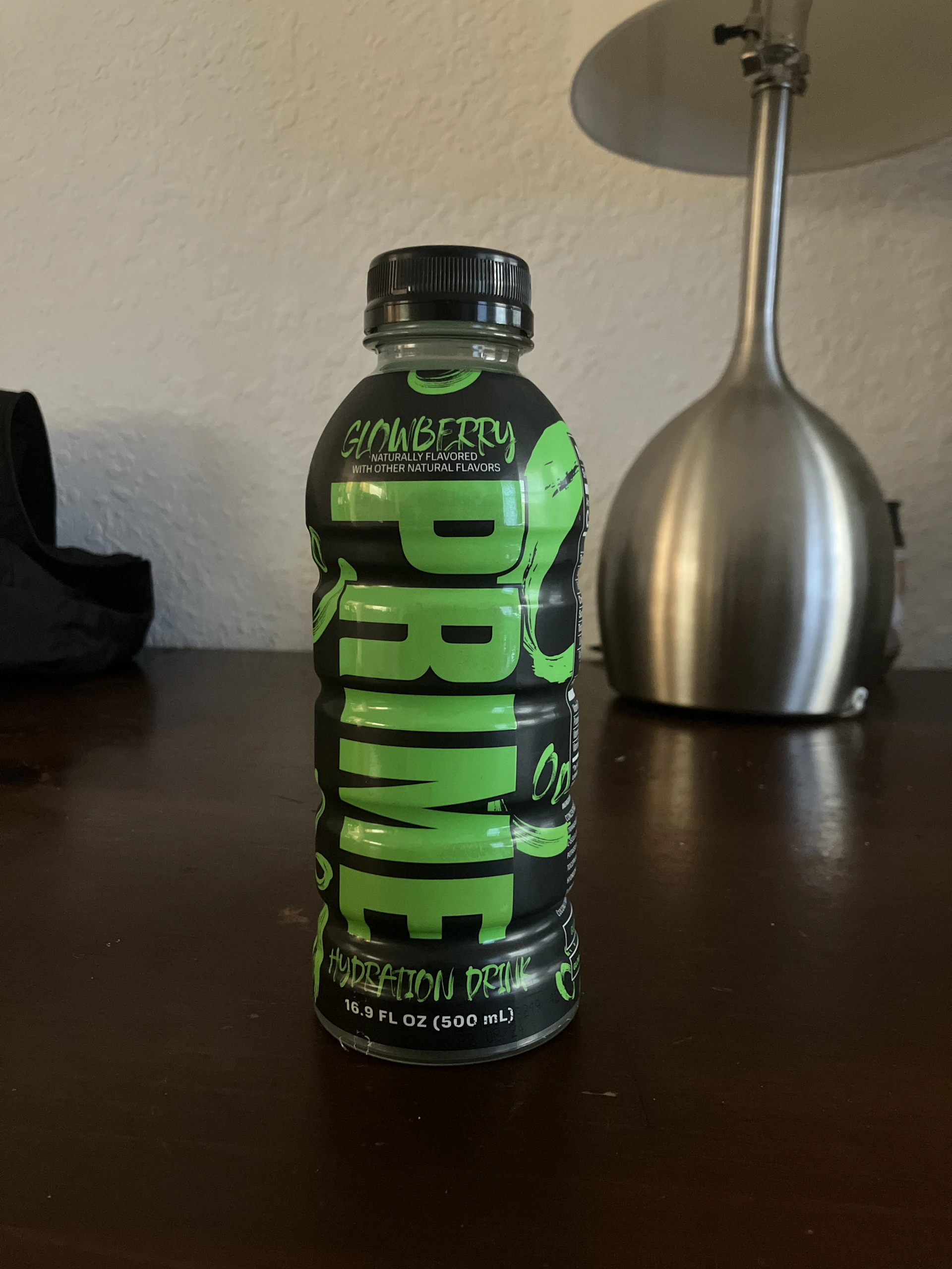 Close-up of the HydroLean XT Gold supplement bottle resting on a sleek black surface, highlighted by sporty gold accents reflecting the brand’s energy.