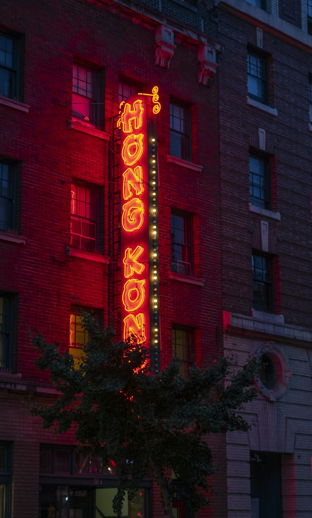 a red neon sign on the side of a building