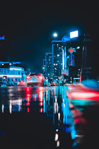 A dynamic urban scene captured at night with vibrant colors and sharp contrasts.