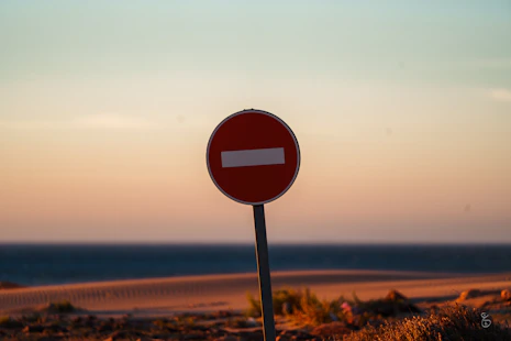 a red street sign sitting on the side of a road