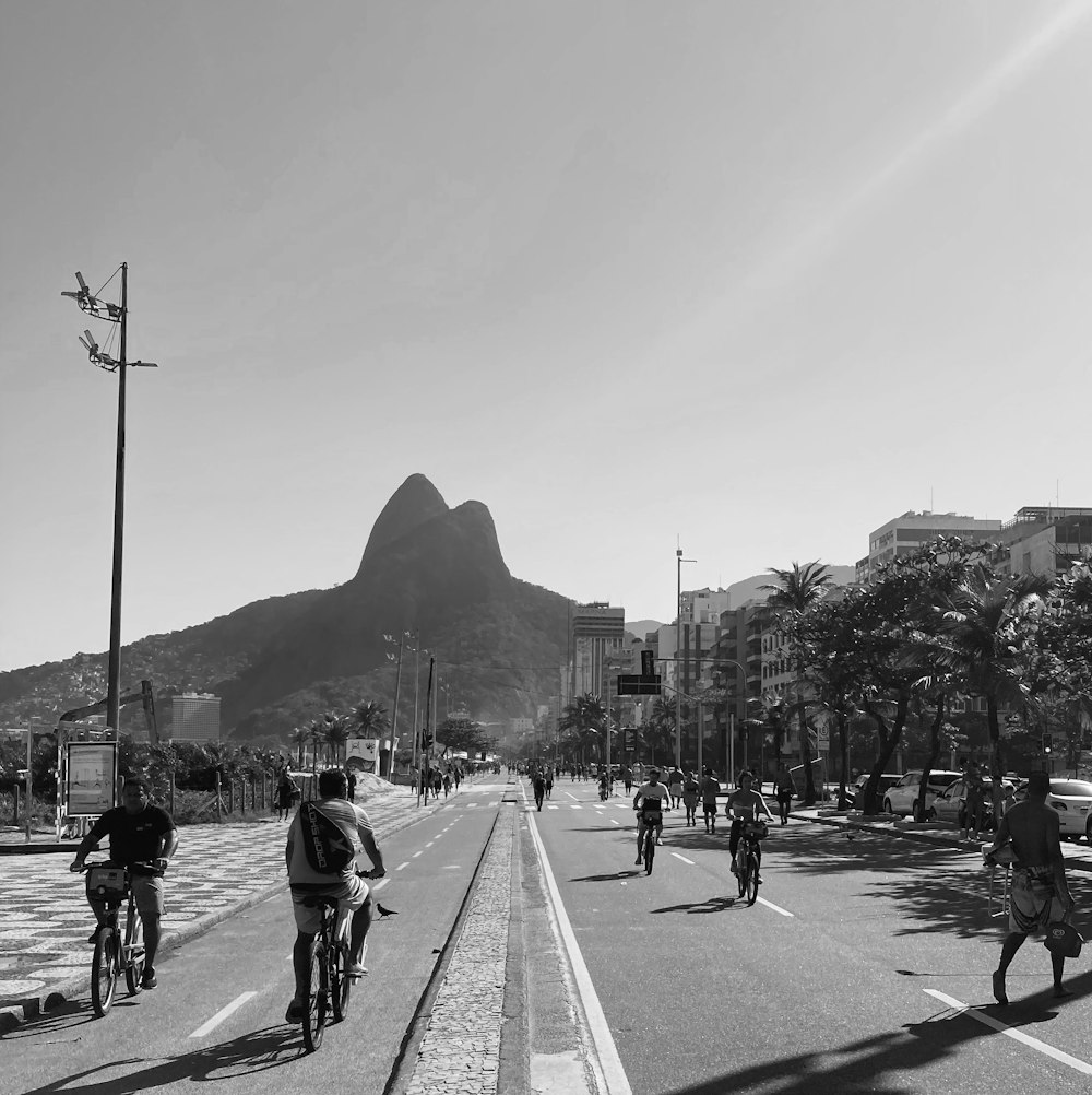 a group of people riding bikes down a street