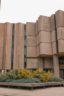 A stark black-and-yellow brutalist styled contact form glowing under harsh spotlights.