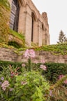 Garden Room exterior showing charming architecture surrounded by blooming flowers.