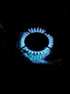 Hydrogen-powered industrial burner installed in a factory setting emitting clean blue flames.