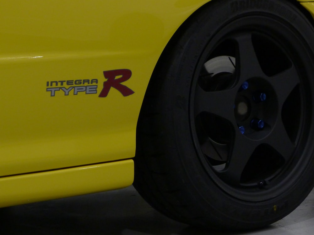 a close up of a yellow sports car tire