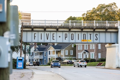 a bridge over a street with cars driving under it