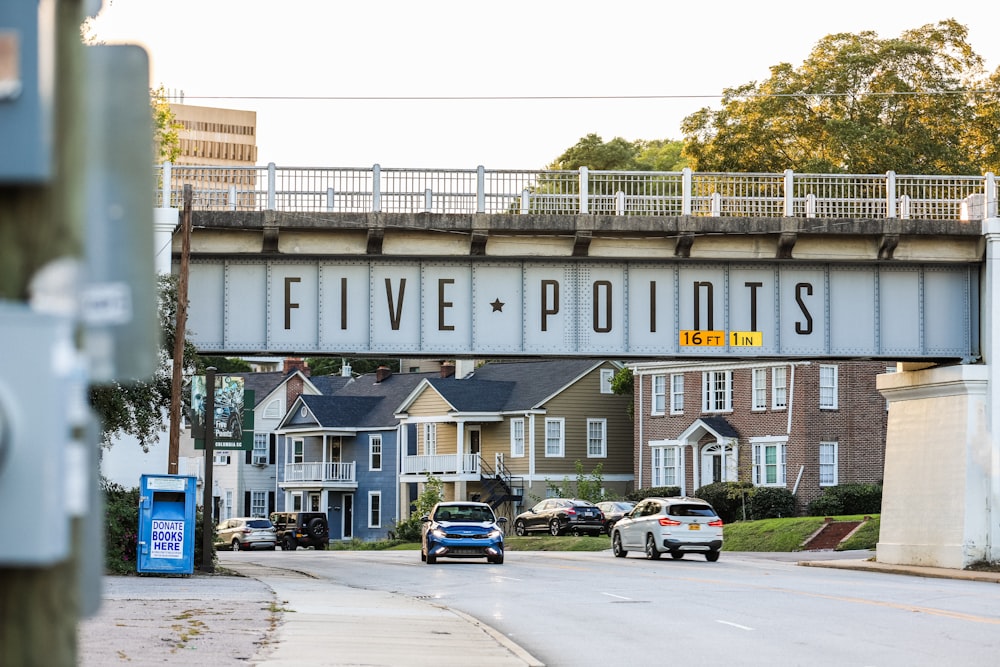 a bridge over a street with cars driving under it