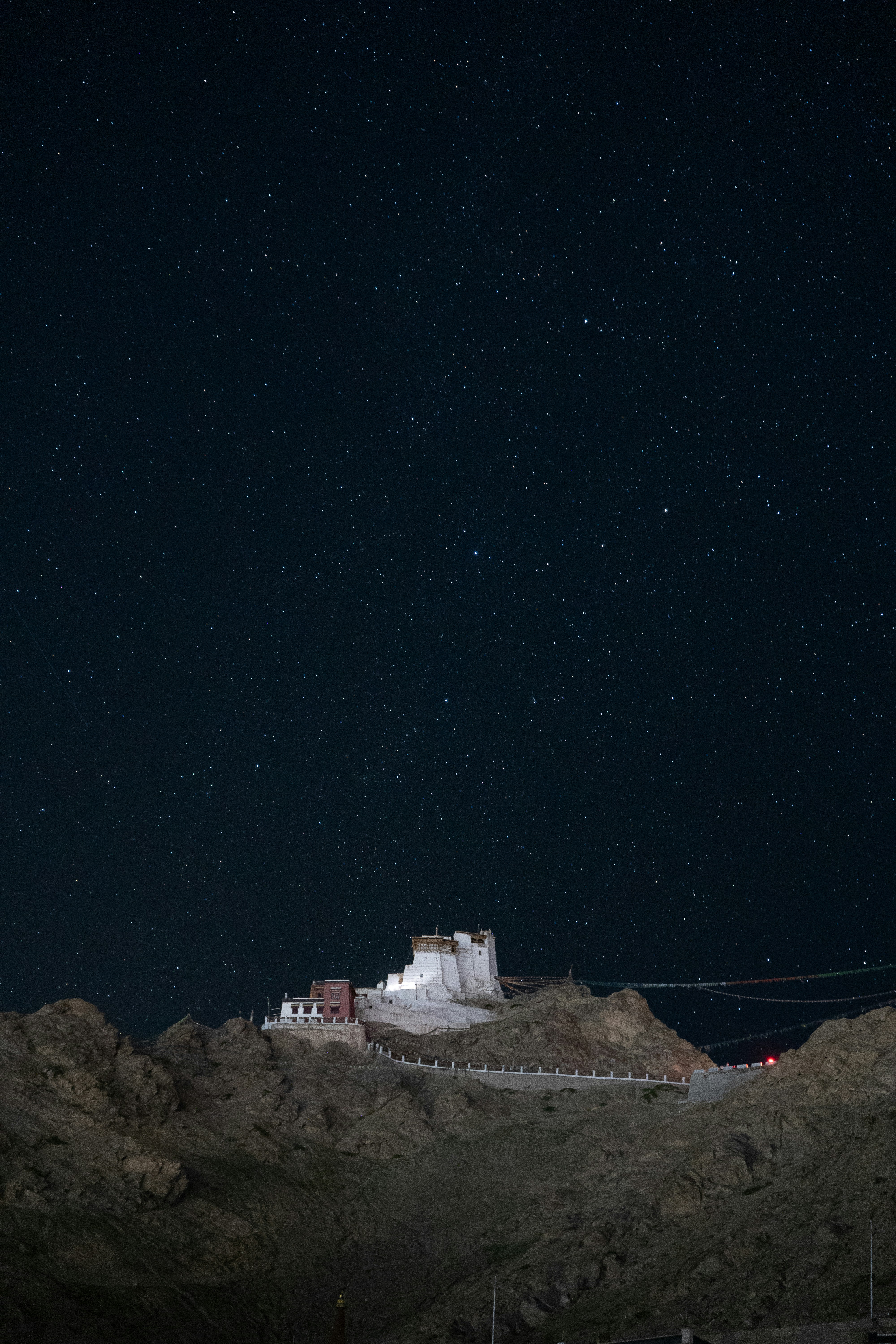 a hill with a building on top of it at night