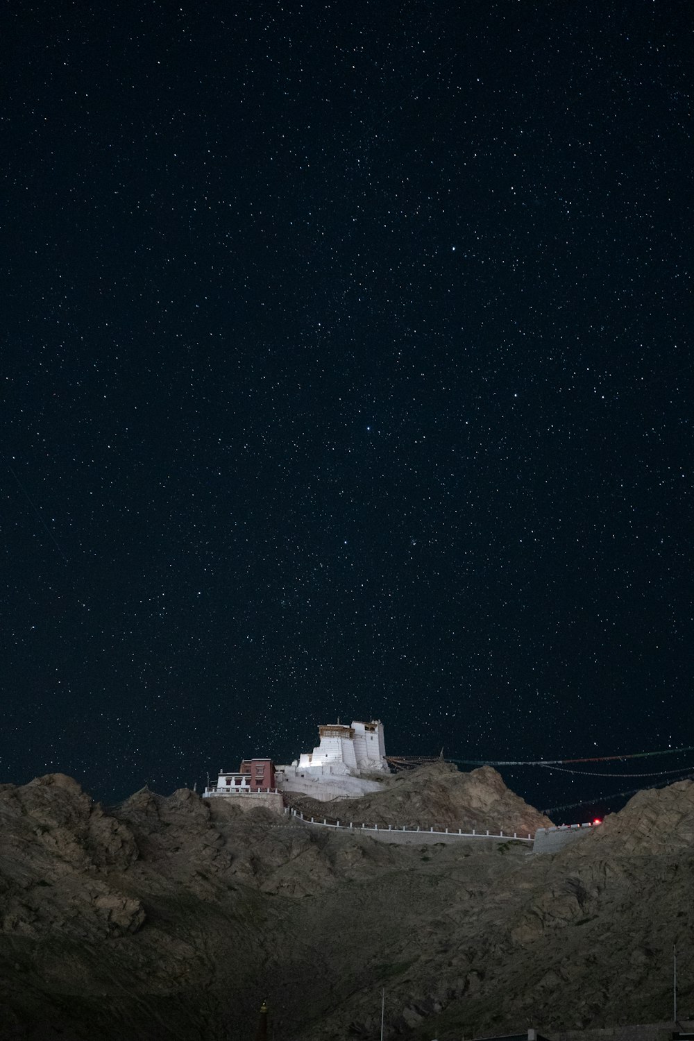 a hill with a building on top of it at night