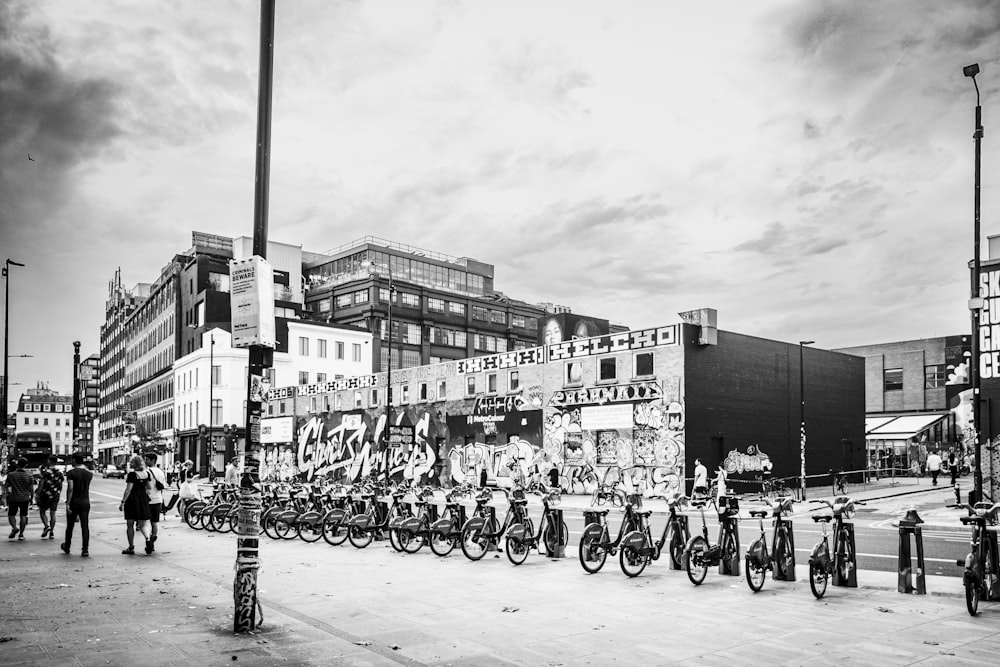a black and white photo of a group of people on bicycles