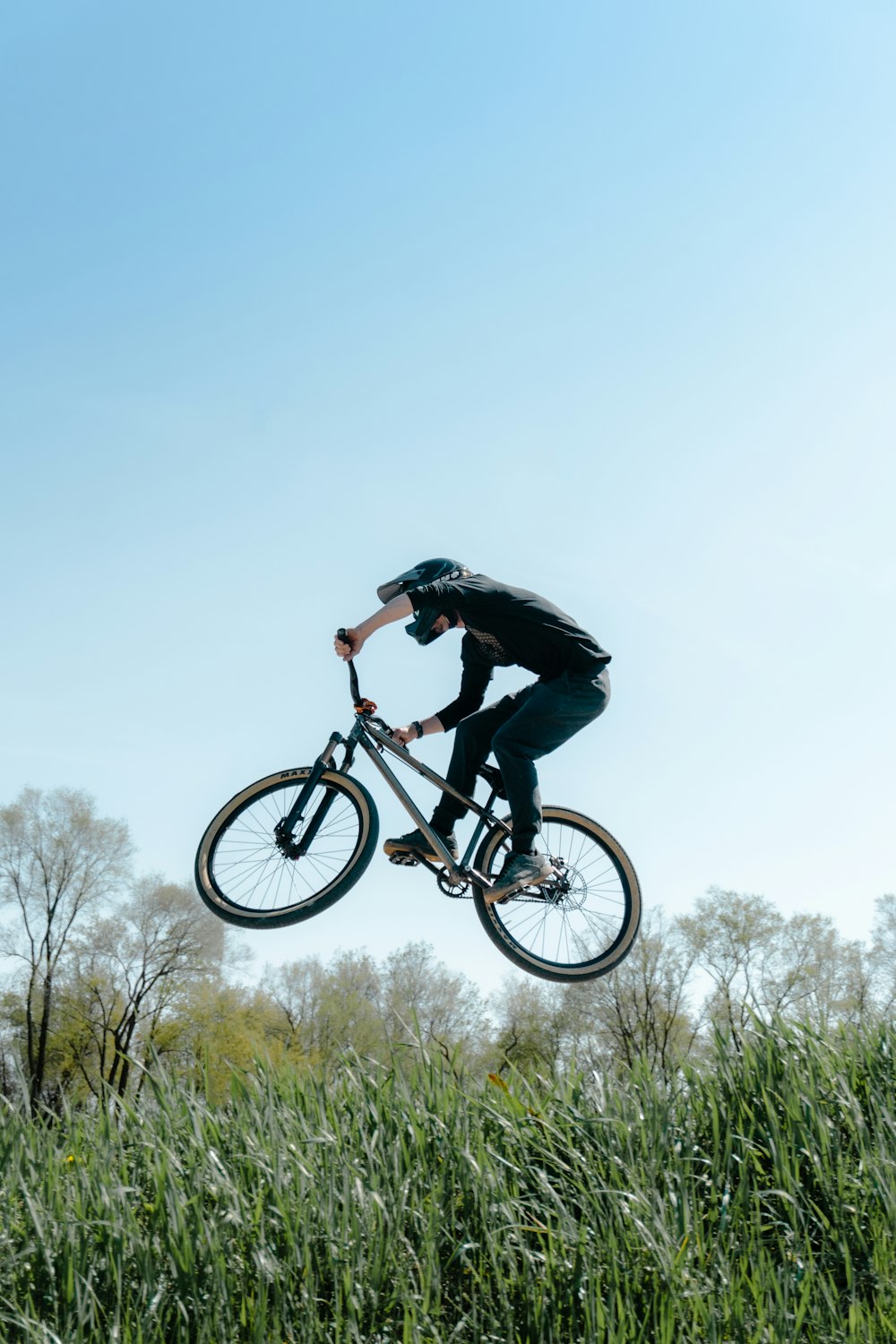 a man riding a bike through the air