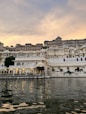 a large white building sitting on top of a lake