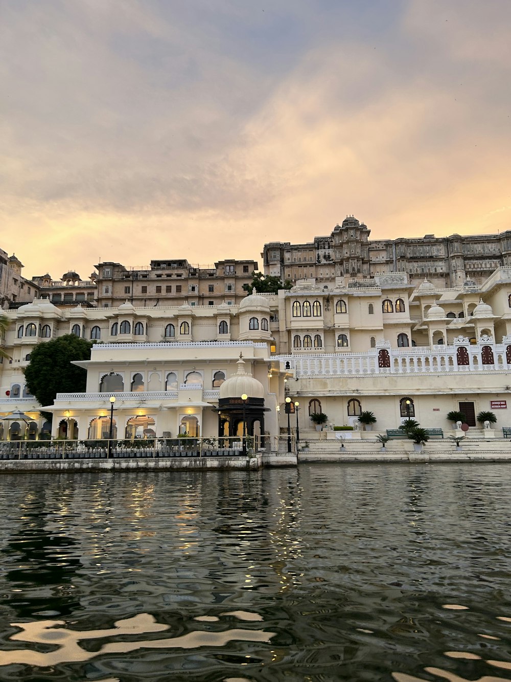 a large white building sitting on top of a lake