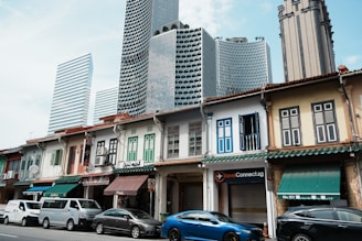 A row of modern shophouses in Bogor with landscaped surroundings and vibrant community activity.