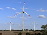 a group of wind turbines in a field