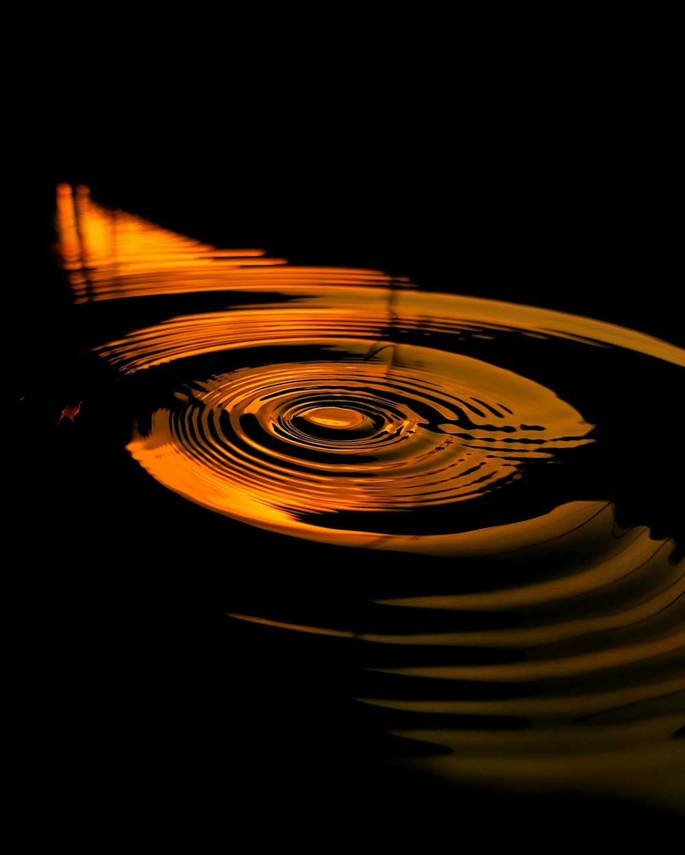 a black and yellow photo of water ripples