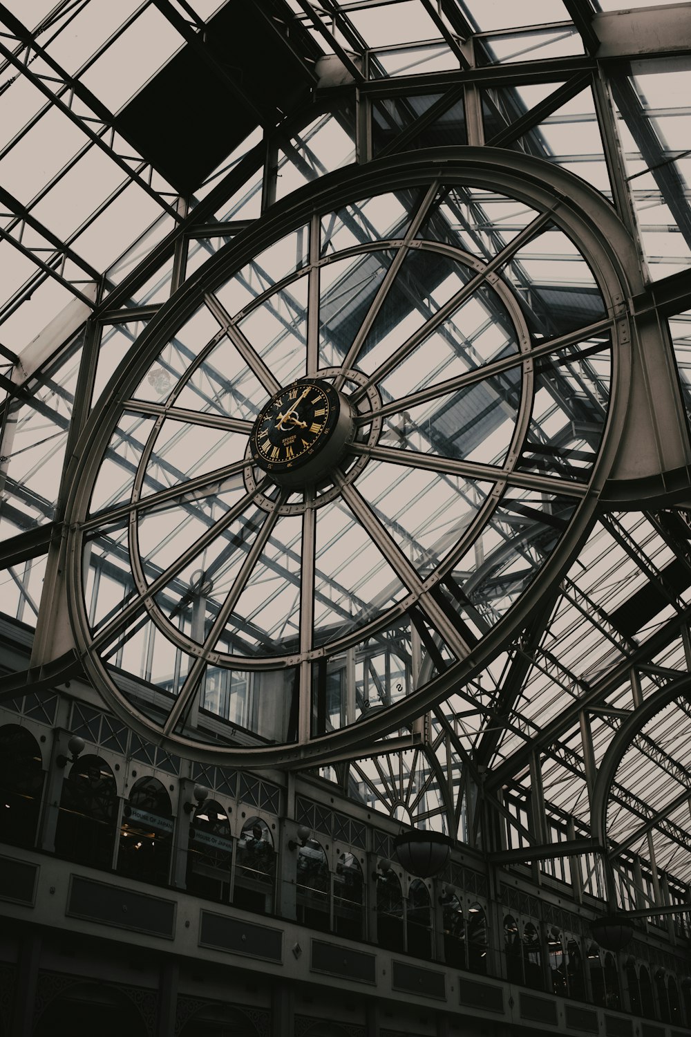 a clock mounted to the ceiling of a building