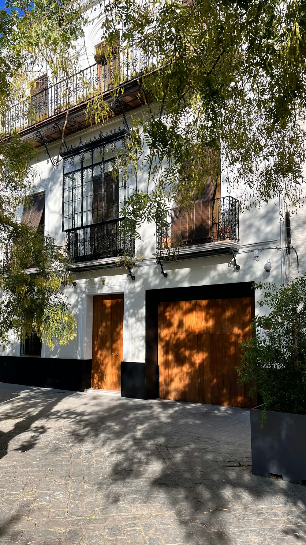 a white house with a brown garage door