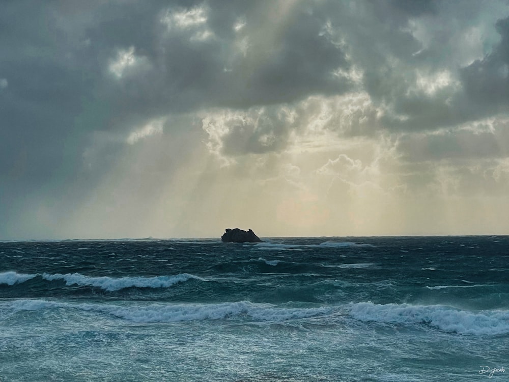 a large body of water under a cloudy sky