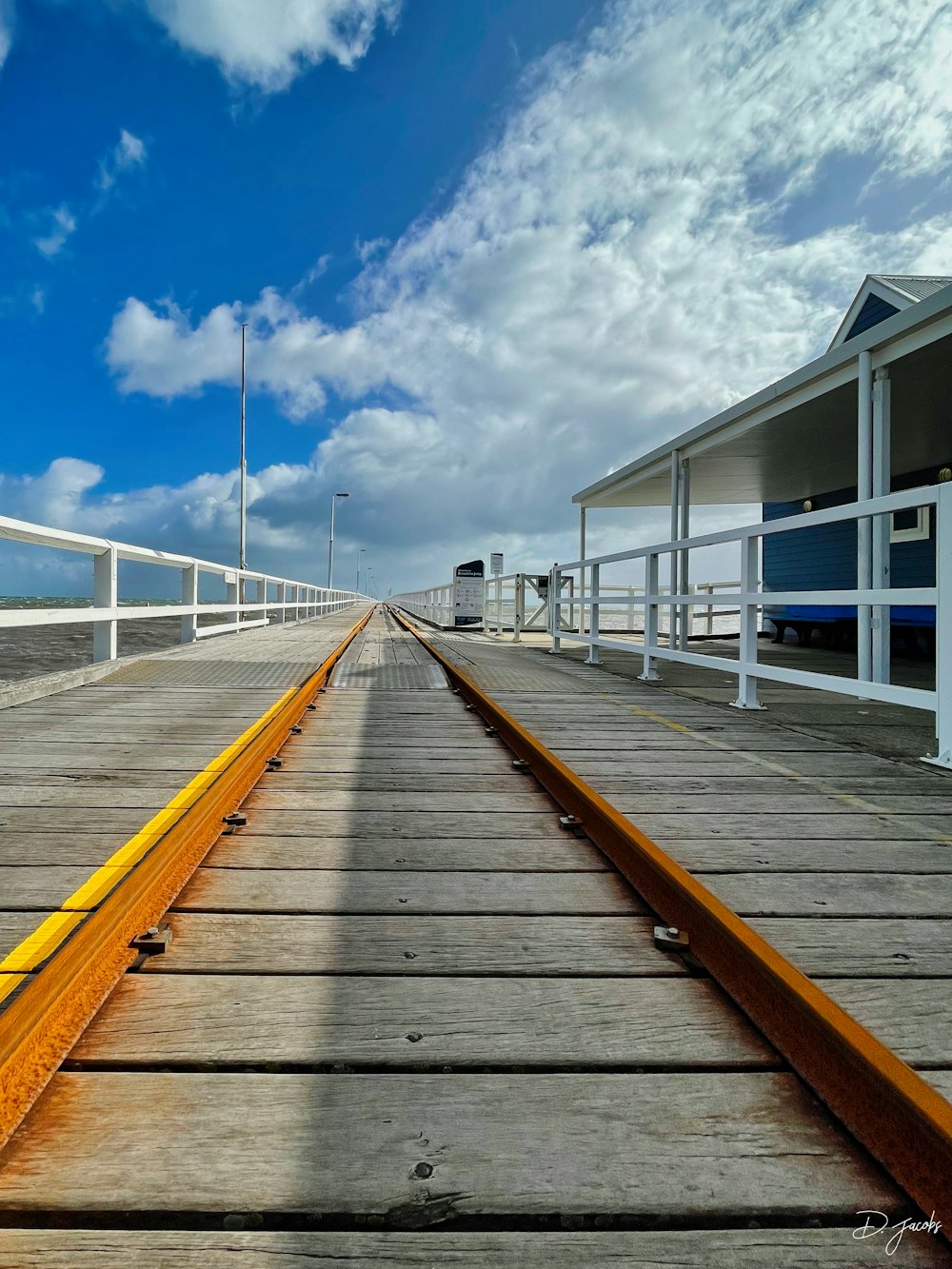 a train track going across a bridge over water