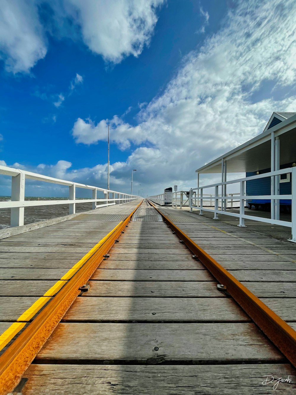 a train track going across a bridge over water