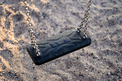 Close-up of sanitized swing chains and seats, showing attention to detail in cleaning.