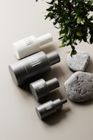 A minimalist display of several perfume bottles arranged on a clean white surface with natural light.