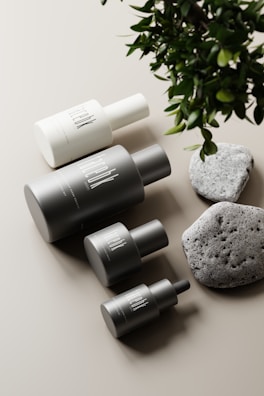 A minimalist arrangement of fragrance bottles with floral accents.