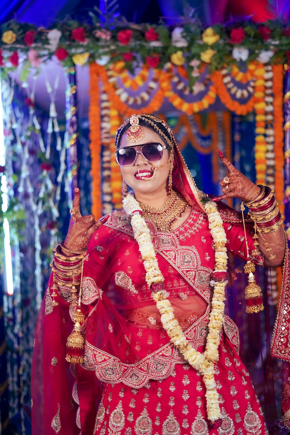 a woman dressed in a red and gold bridal outfit