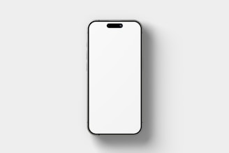 A modern smartphone with a blank white screen is centered against a plain light gray background. The phone has thin bezels and a small cutout for the front camera and speaker at the top.
