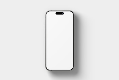 A modern smartphone with a blank white screen is centered against a plain light gray background. The phone has thin bezels and a small cutout for the front camera and speaker at the top.