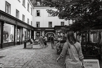 A cozy street scene in Hamburg-Neugraben with local shops and greenery on a sunny day.