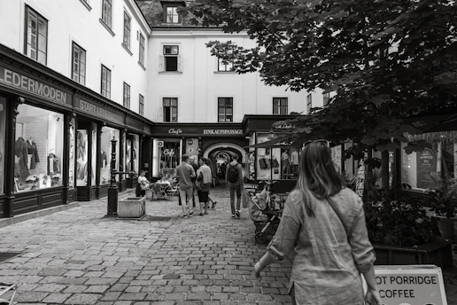 A cozy street scene in Hamburg-Neugraben with local shops and greenery on a sunny day.