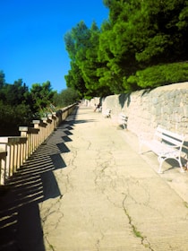 Sunlit footpath lined with quaint murets and traditional calvaries for a peaceful stroll