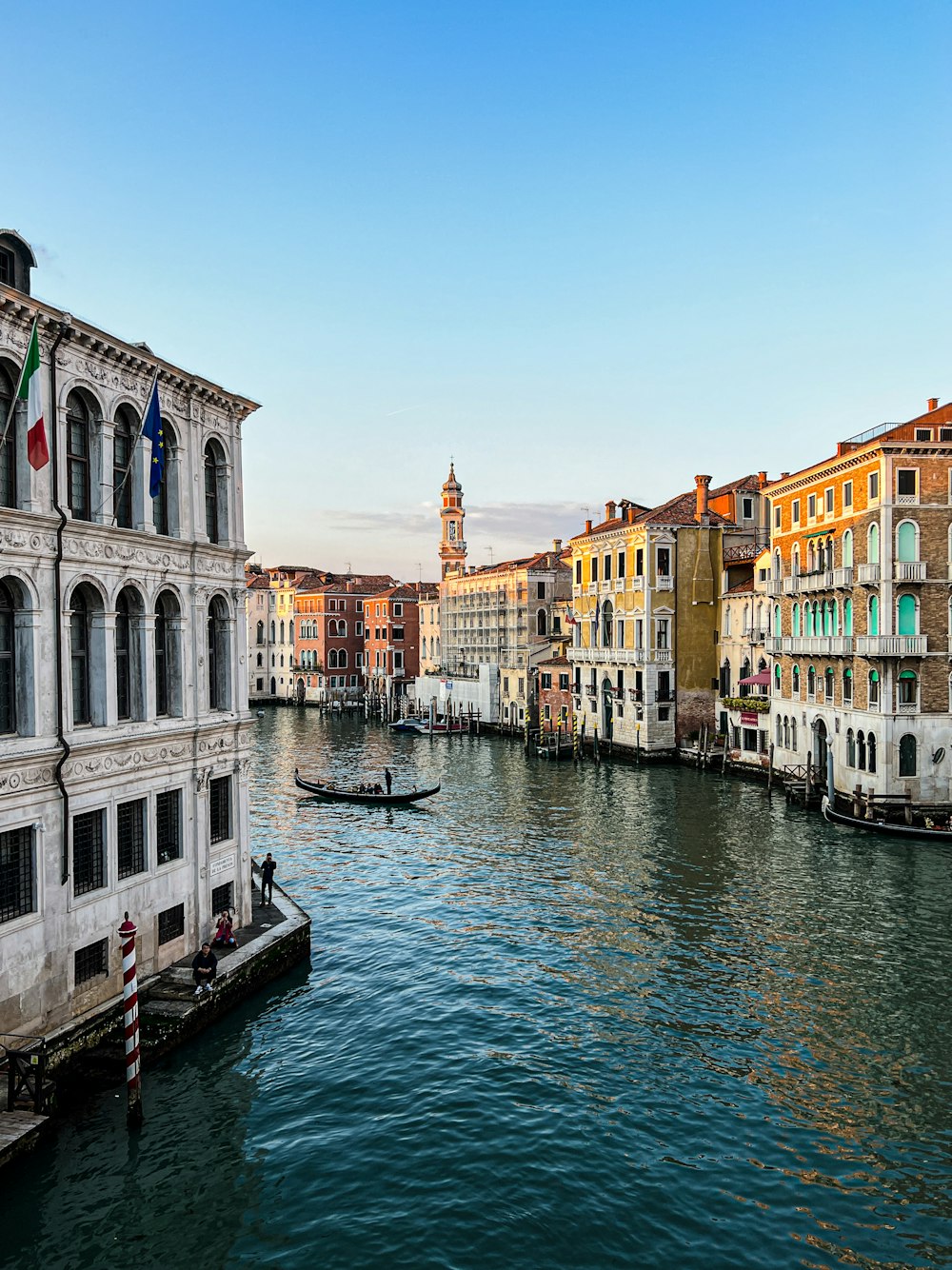 a canal with several buildings and a boat in the water