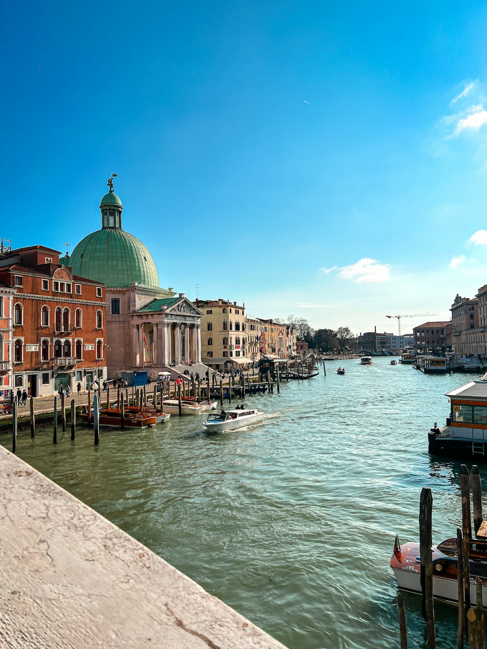 a view of a waterway with boats and buildings in the background