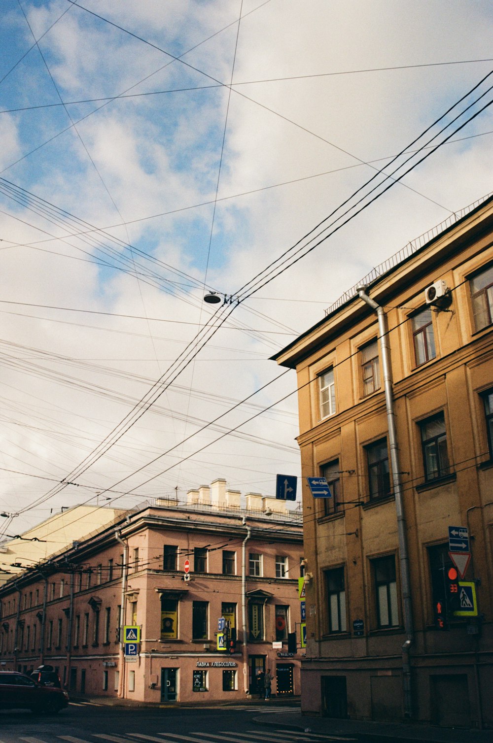 a city street with buildings and wires above it