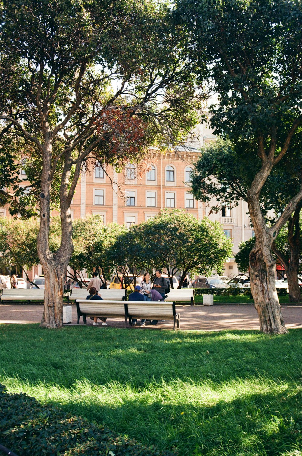 a group of people sitting on a park bench