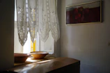 A sunlit Italian living room blending warm woods and soft textiles with handcrafted art pieces.