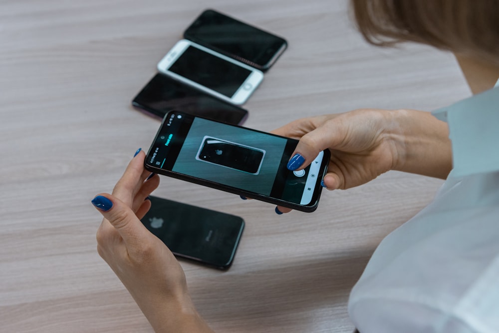 a woman holding a smart phone in her hands