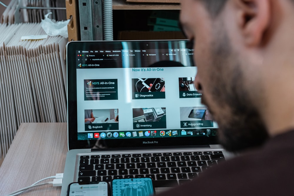 a man sitting in front of a laptop computer