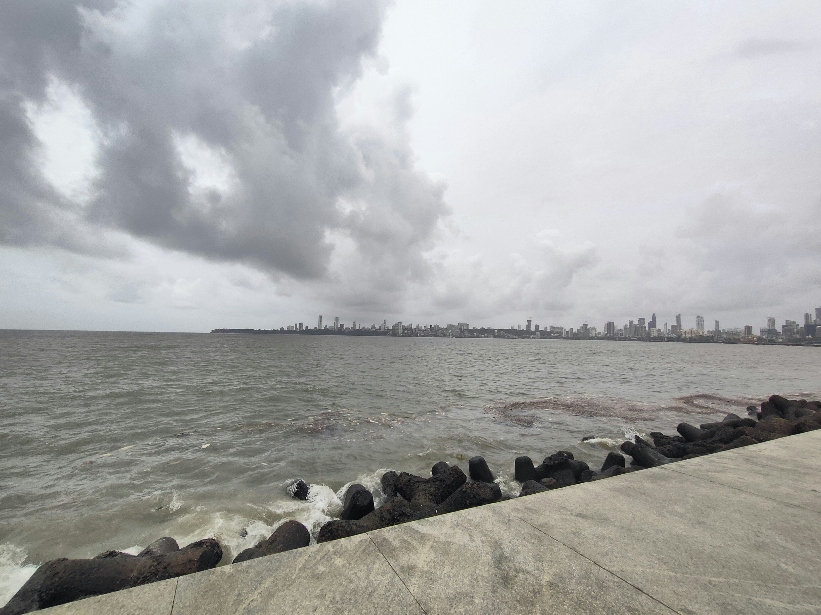 a large body of water with a city in the background