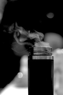 Close-up of a travel thermos with steam rising from it.