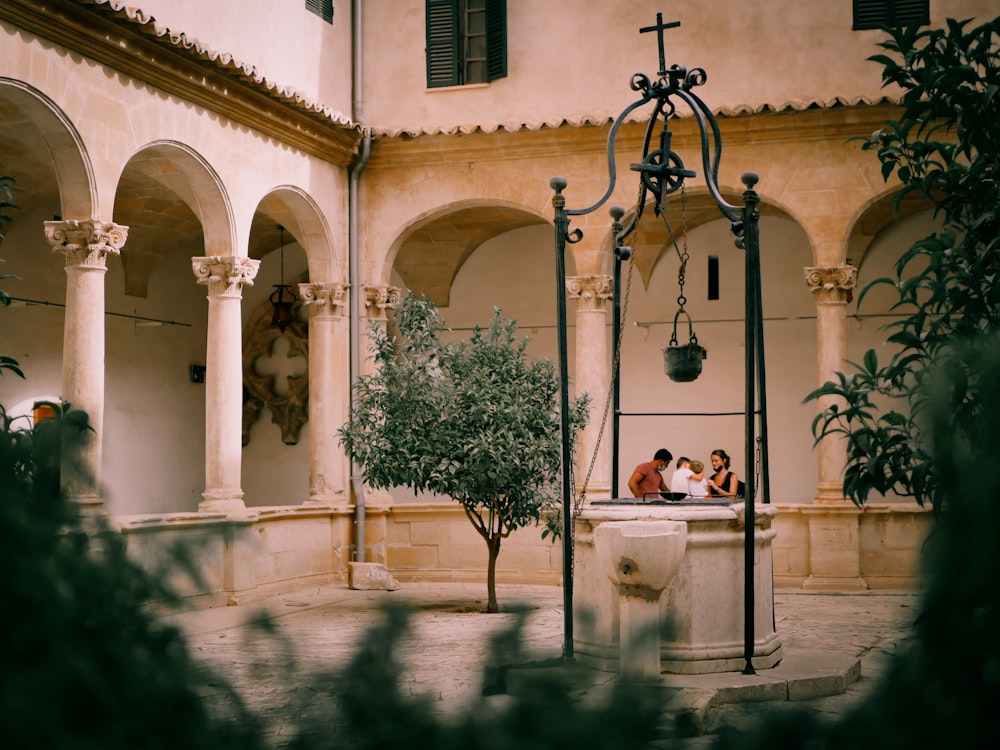 two people sitting on a bench in a courtyard