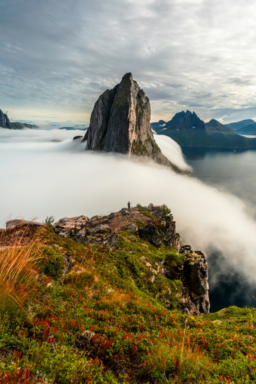 a mountain covered in fog and low lying clouds