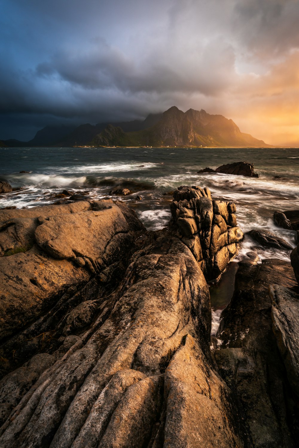 a rocky beach with waves crashing against the rocks