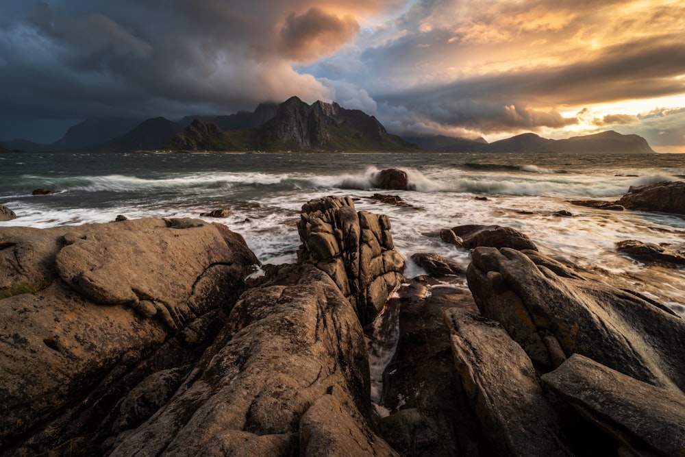 a rocky beach with waves crashing against the rocks