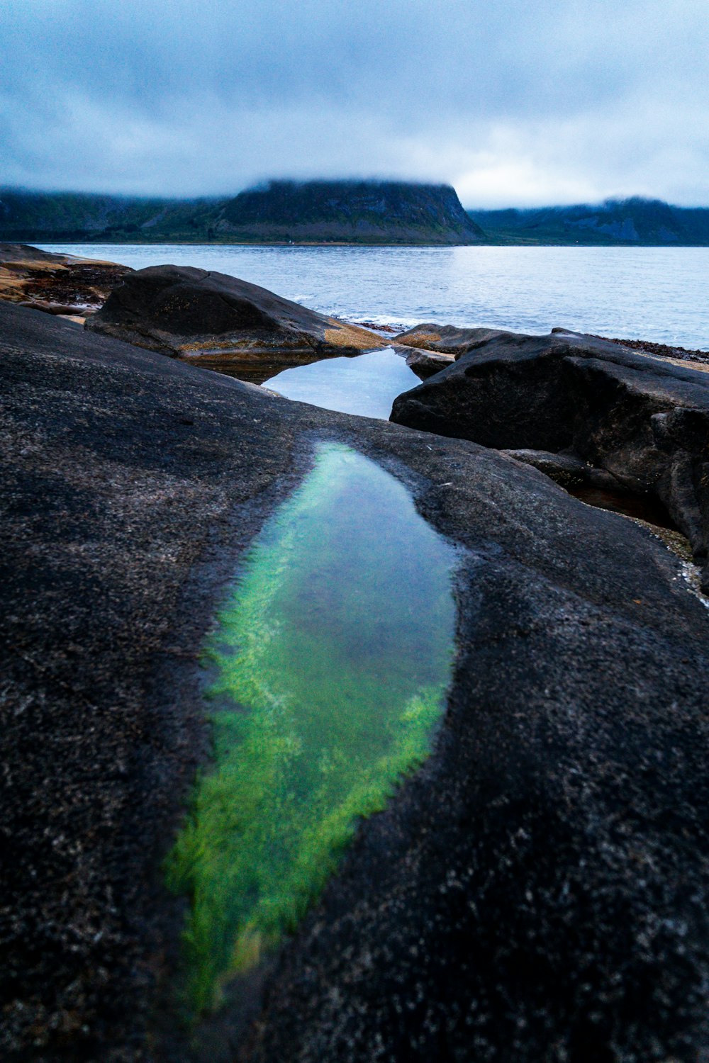 a body of water that is next to some rocks