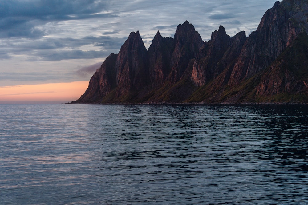 a large body of water with mountains in the background