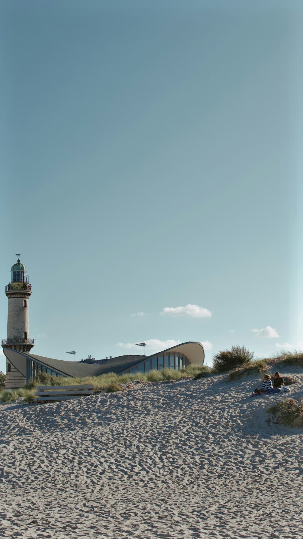 a light house sitting on top of a sandy beach